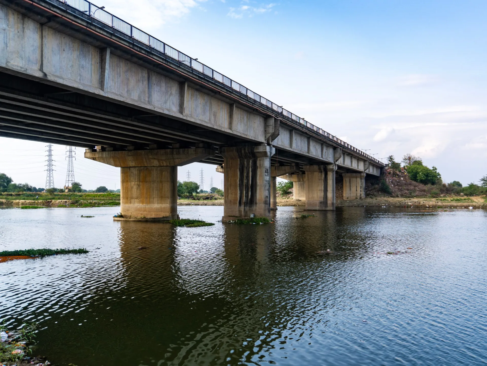 Concrete beam bridge on piers crossing a river