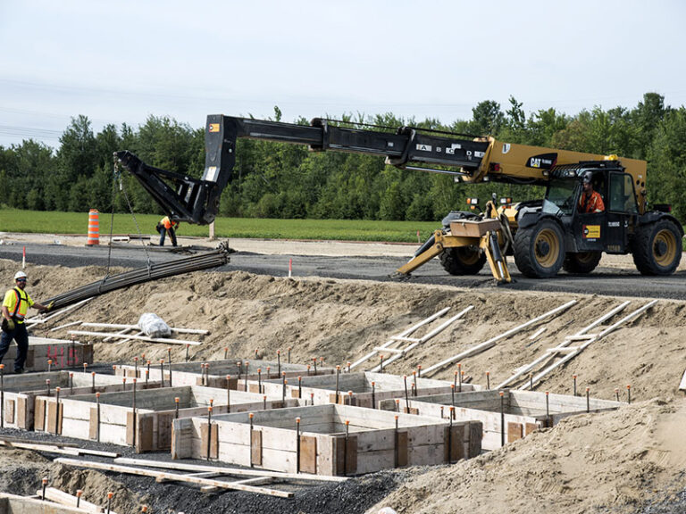 Concrete foundation formwork and reinforcement placed with a telehandler on a civil construction site