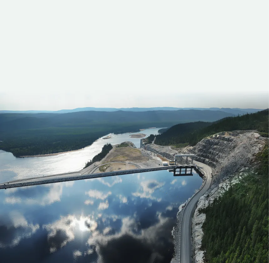 Aerial view of a hydroelectric dam and reservoir in boreal forest terrain