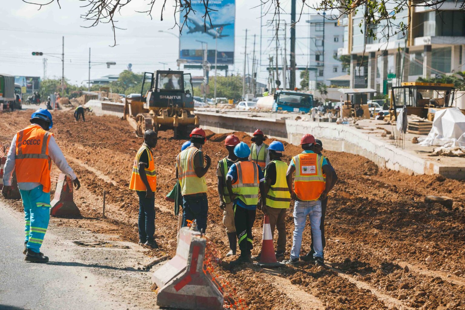 Site crew in high visibility clothing supervising roadway upgrading works