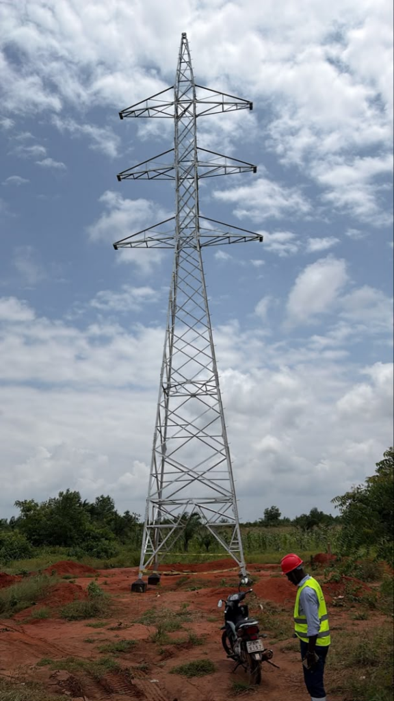 TAWARA engineer inspecting an erected 63 kV double circuit lattice steel tower on the Gakpe to Ouidah transmission line in Benin