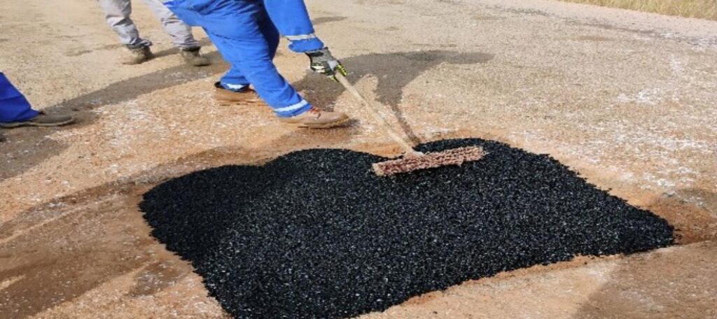 Cold asphalt raked into a pothole repair on the Madjo to Doba national road in Chad