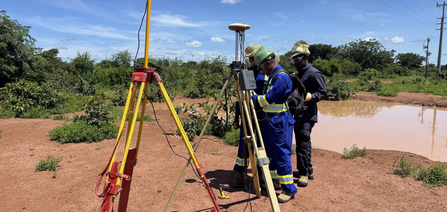 Survey crew operating a GNSS base station and total station on the Kome 4 to Doba road corridor in Chad