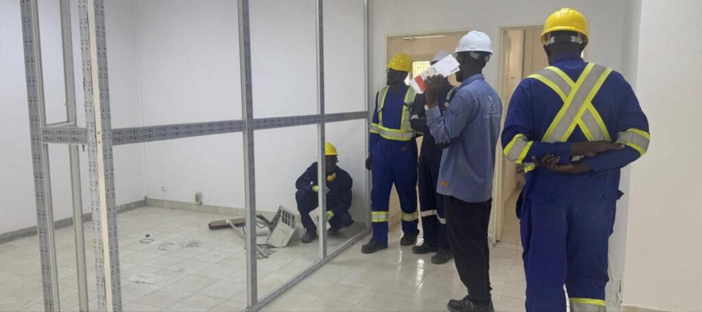 Crews installing interior partitions during the villa-to-office conversion for TOTCO in N’Djamena